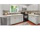 Bright kitchen featuring stainless steel appliances, stylish backsplash, and wood flooring at 5409 Knollwood Rd Rd, Raleigh, NC 27609