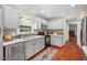 Well-lit kitchen with stainless steel appliances, a window over the sink, and wood floors at 5409 Knollwood Rd Rd, Raleigh, NC 27609