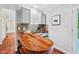 Living room featuring a wet bar area, wooden countertops, and a stylish backsplash at 5409 Knollwood Rd Rd, Raleigh, NC 27609