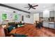 Open living room with hardwood floors, breakfast bar, brick fireplace, and access to backyard at 5409 Knollwood Rd Rd, Raleigh, NC 27609