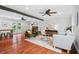 Spacious living room with hardwood floors, ceiling fans, neutral paint, and access to back yard at 5409 Knollwood Rd Rd, Raleigh, NC 27609