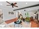Inviting living room with hardwood floors, ceiling fan, brick fireplace, and neutral wall color at 5409 Knollwood Rd Rd, Raleigh, NC 27609