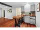 Charming living room with hardwood floors, bar area, and mini fridge for convenience at 5409 Knollwood Rd Rd, Raleigh, NC 27609