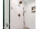 Close up view of a modern shower featuring designer tilework, a rainfall showerhead, and built-in shelving at 5409 Knollwood Rd Rd, Raleigh, NC 27609