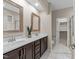 Bathroom featuring double sinks, a neutral color palette, and a doorway to the toilet at 5644 Wade Park Blvd, Raleigh, NC 27607