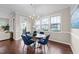 Dining area with hardwood floors, backyard view, and table with seating for four at 5644 Wade Park Blvd, Raleigh, NC 27607