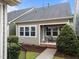 Charming home exterior featuring a welcoming front porch with a seating area and well-maintained landscaping at 5644 Wade Park Blvd, Raleigh, NC 27607