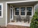 Inviting front porch featuring classic rocking chairs and a charming entrance at 5644 Wade Park Blvd, Raleigh, NC 27607