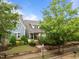 Beautiful home exterior featuring mature trees, lush lawn, and a well-maintained yard at 5644 Wade Park Blvd, Raleigh, NC 27607