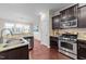 Modern kitchen with stainless steel appliances, granite countertops, and a view into the bright dining area at 5644 Wade Park Blvd, Raleigh, NC 27607