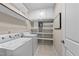 Functional laundry room with washer, dryer, and storage shelving for convenience at 5644 Wade Park Blvd, Raleigh, NC 27607