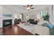 Cozy living room featuring a fireplace, hardwood floors, neutral decor, and comfortable seating at 5644 Wade Park Blvd, Raleigh, NC 27607