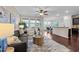 Open-concept living area with hardwood floors, large windows, and a seamless flow into the dining space at 5644 Wade Park Blvd, Raleigh, NC 27607