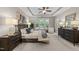 The main bedroom features a neutral color palette, ceiling fan, and many windows at 5644 Wade Park Blvd, Raleigh, NC 27607