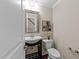 Comfortable powder room with mirror and dark wooden accents at 5644 Wade Park Blvd, Raleigh, NC 27607