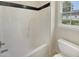 Clean bathroom with a white shower-tub combo and a toilet at 5749 Stone Crystal Dr, Fuquay Varina, NC 27526