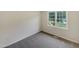 Bright bedroom featuring plush carpet and a large window providing ample natural light at 5749 Stone Crystal Dr, Fuquay Varina, NC 27526