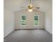 A bright bedroom features two windows providing ample natural light at 5749 Stone Crystal Dr, Fuquay Varina, NC 27526