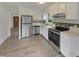 Stainless steel appliances and white cabinets in this well-lit kitchen at 5749 Stone Crystal Dr, Fuquay Varina, NC 27526