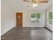 Well-lit living room featuring sleek hard wood floors and a contemporary ceiling fan at 5749 Stone Crystal Dr, Fuquay Varina, NC 27526