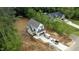 Aerial view of new construction home in a wooded area with completed driveway at 60 Purslane Dr, Franklinton, NC 27525