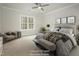 Bedroom with a ceiling fan, large window, neutral walls, a sitting area, and modern decor at 60 Purslane Dr, Franklinton, NC 27525