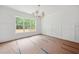 Bright dining room with large window, chandelier lighting, and white trim at 60 Purslane Dr, Franklinton, NC 27525