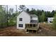 Back exterior view featuring a newly-built home with a rear deck and ample yard space at 60 Purslane Dr, Franklinton, NC 27525