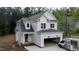 New construction home with white siding, covered garage, and brick-lined front porch at 60 Purslane Dr, Franklinton, NC 27525