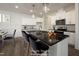 Bright kitchen featuring white cabinets, granite countertops, and an island with bar seating, virtually staged at 60 Purslane Dr, Franklinton, NC 27525