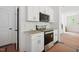 White kitchen with stainless appliances and white subway tile backsplash at 60 Purslane Dr, Franklinton, NC 27525