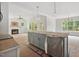 Spacious eat-in kitchen featuring an island with gray cabinets, modern lighting and a fireplace at 60 Purslane Dr, Franklinton, NC 27525