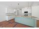 Unfinished kitchen featuring white cabinets, stainless appliances, an island and pendant lighting at 60 Purslane Dr, Franklinton, NC 27525