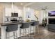Modern kitchen with white cabinetry, stainless steel appliances, and island seating, virtually staged at 60 Purslane Dr, Franklinton, NC 27525