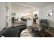 Open-concept living room with a view of the modern kitchen and dining area, virtually staged at 60 Purslane Dr, Franklinton, NC 27525