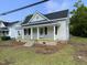 Charming single-Gathering home with a covered front porch and fresh landscaping details at 609 N Magnolia Ave, Dunn, NC 28334
