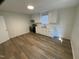 Modern kitchen features white cabinets, new appliances, and wood-look flooring at 609 N Magnolia Ave, Dunn, NC 28334