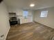 Modern kitchen features white cabinets, new appliances, and wood-look flooring at 609 N Magnolia Ave, Dunn, NC 28334