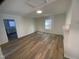 Bright living room featuring new wood flooring and neutral paint colors at 609 N Magnolia Ave, Dunn, NC 28334