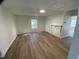 Bright living room featuring new wood flooring and neutral paint colors at 609 N Magnolia Ave, Dunn, NC 28334