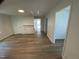 Bright living room featuring new wood flooring and neutral paint colors at 609 N Magnolia Ave, Dunn, NC 28334