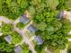 Drone shot featuring multiple homes with tree-lined streets at 6321 Lymington Dr, Raleigh, NC 27616