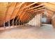 Unfinished attic space showing exposed beams, plywood flooring, and insulation at 6321 Lymington Dr, Raleigh, NC 27616