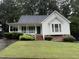 Charming one-story home featuring a welcoming front porch and well-maintained landscaping at 6321 Lymington Dr, Raleigh, NC 27616