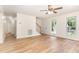 Bright and open living room with hardwood floors, ceiling fan, and staircase at 6321 Lymington Dr, Raleigh, NC 27616