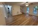 Bright living room featuring wood flooring, a ceiling fan, and access to the upper floor at 6321 Lymington Dr, Raleigh, NC 27616