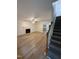 Spacious living room featuring a fireplace and wood flooring. Stairs leading to the upper floor at 6321 Lymington Dr, Raleigh, NC 27616