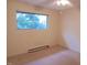 Bright bedroom with a ceiling fan and a large window offering scenic outdoor views at 7 Shepherd Ln # Bldg D, Chapel Hill, NC 27514