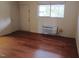 Minimalist bedroom with a hardwood floor, a window and air conditioner at 7 Shepherd Ln # Bldg D, Chapel Hill, NC 27514
