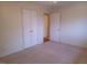 Neutral carpeted bedroom featuring double closets and an open doorway at 7 Shepherd Ln # Bldg D, Chapel Hill, NC 27514
